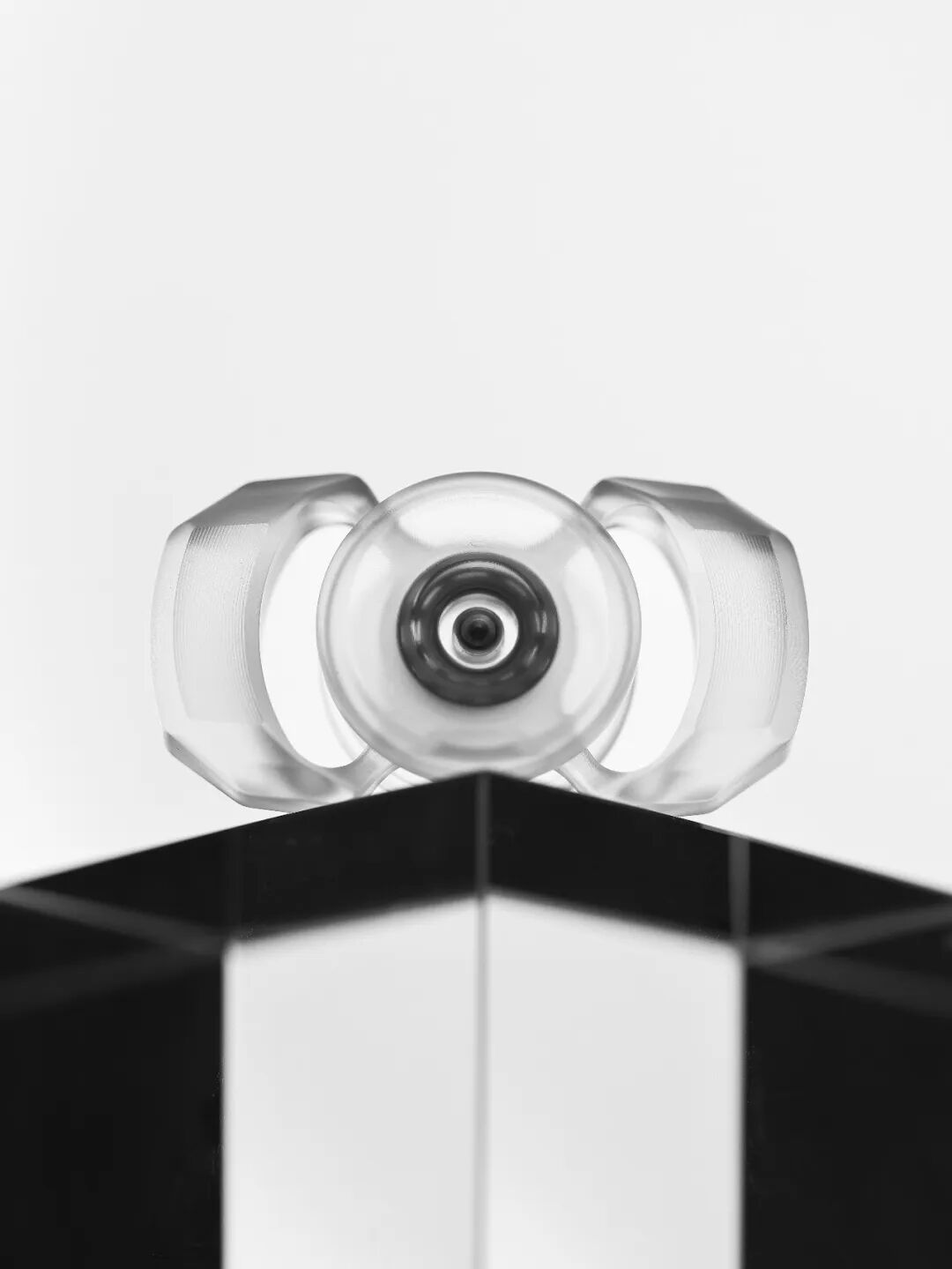 A transparent, two-lobed Whisper-Duo with a circular component visible at its centre