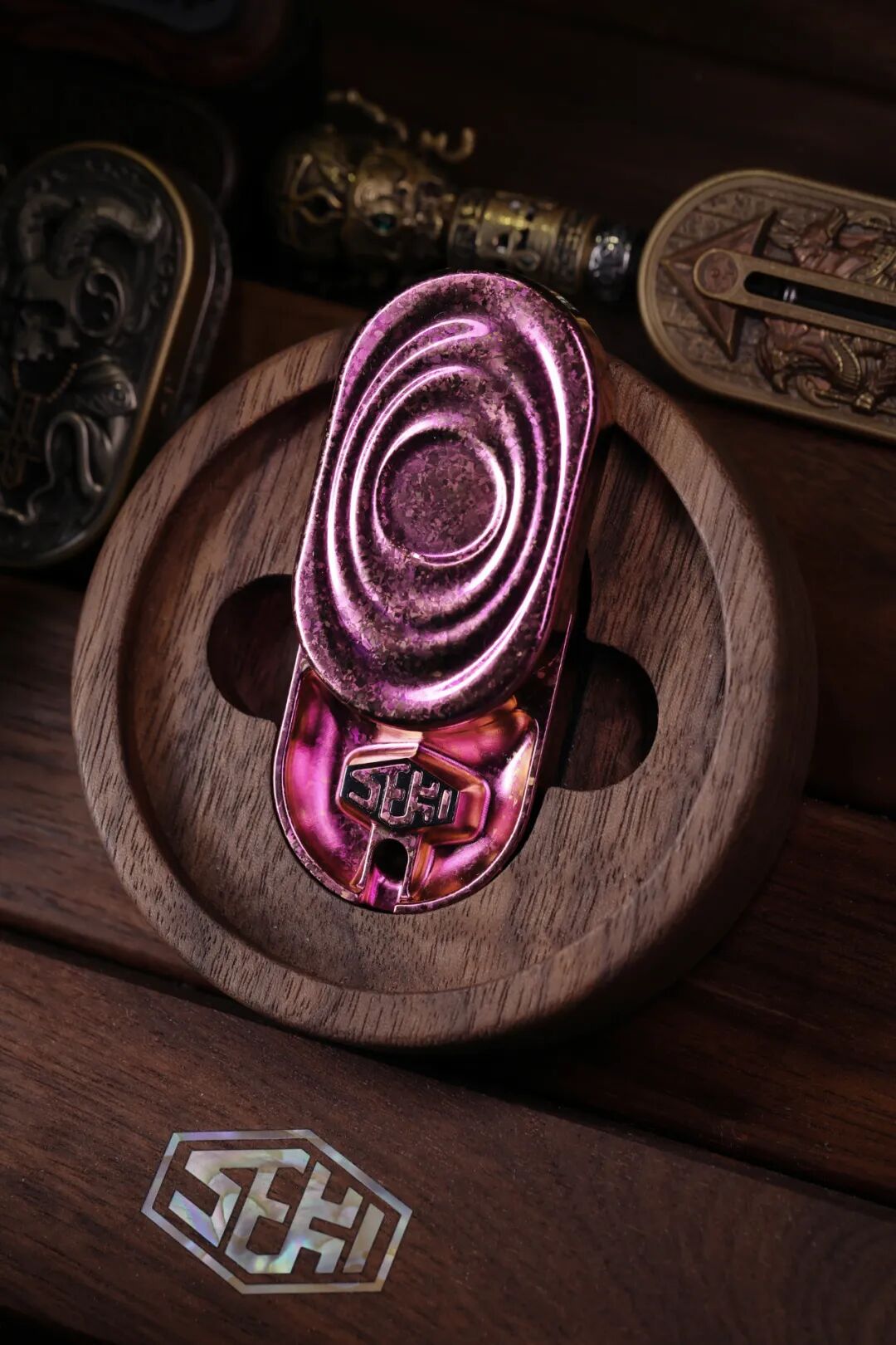 A purple SEKI Bo 3.0 crystallized-titanium sample with patchy crystal patterns across its wave-like ridges.