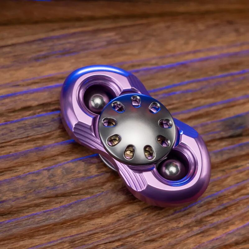 A purple two-arm Jilian with a gunmetal-coloured button and a steel ball at each end
